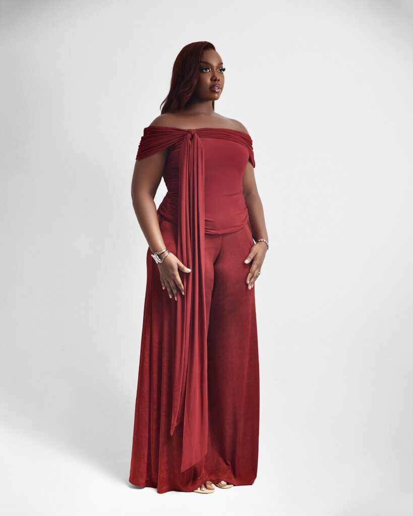 Woman wearing Hannifa, a red off-shoulder Bardot two-piece set with wide-leg trousers by XELENE.